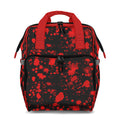 Backpack with red splatter pattern on a black background