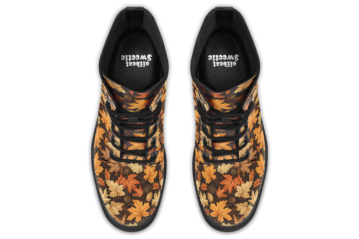 Dark brown boots featuring a pattern of autumn leaves in different shades of browns