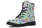 Light blue boots with a pattern of different coloured cute baby dinosaurs, prehistoric-looking trees and dinosaur eggs