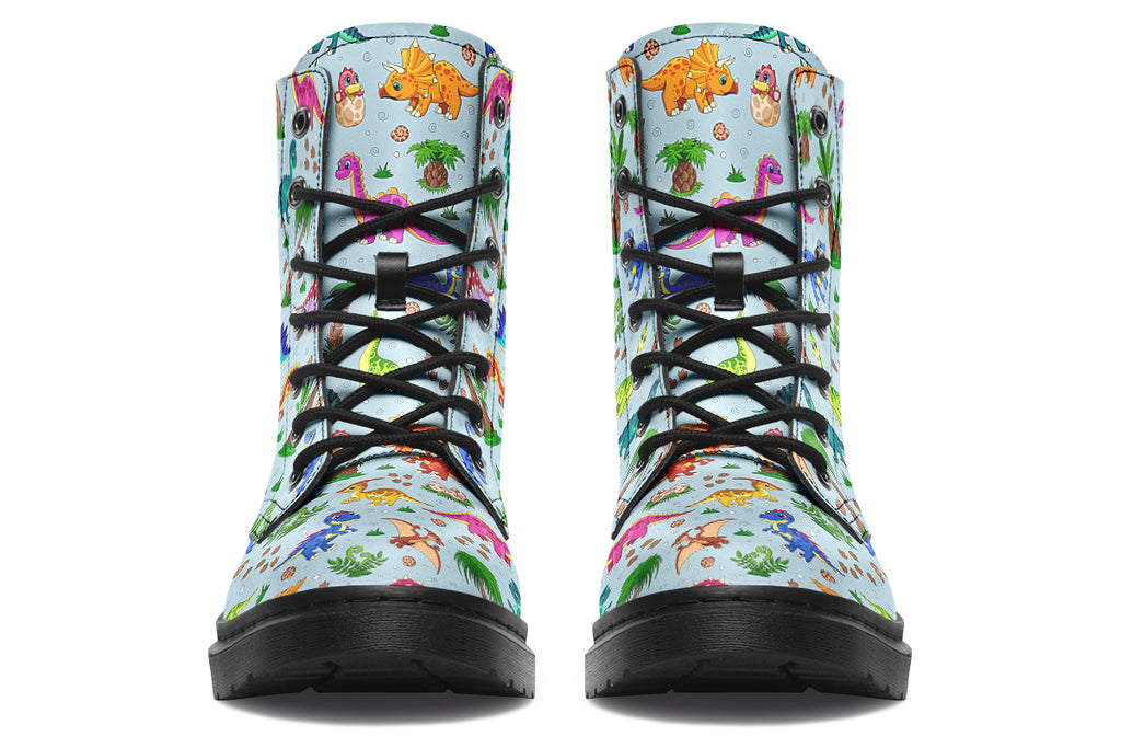 Light blue boots with a pattern of different coloured cute baby dinosaurs, prehistoric-looking trees and dinosaur eggs