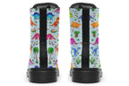 Light blue boots with a pattern of different coloured cute baby dinosaurs, prehistoric-looking trees and dinosaur eggs