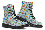 Light blue boots with a pattern of different coloured cute baby dinosaurs, prehistoric-looking trees and dinosaur eggs