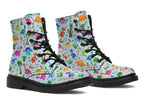 Light blue boots with a pattern of different coloured cute baby dinosaurs, prehistoric-looking trees and dinosaur eggs