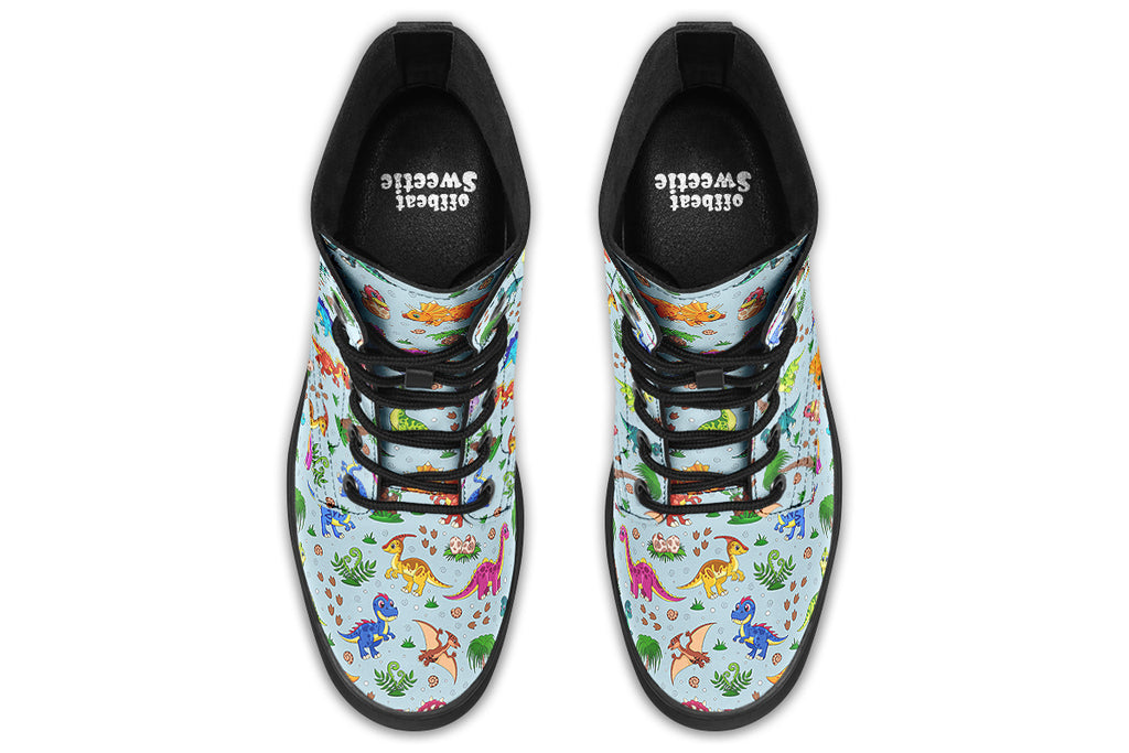 Light blue boots with a pattern of different coloured cute baby dinosaurs, prehistoric-looking trees and dinosaur eggs