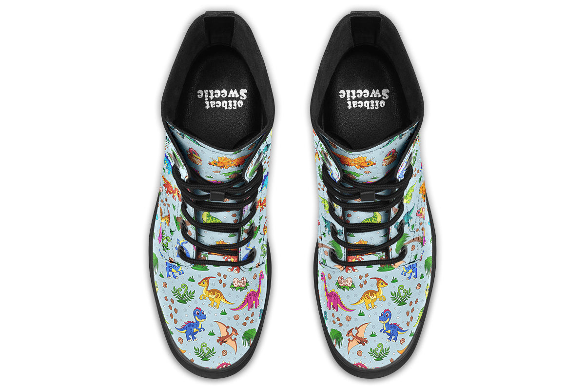 Light blue boots with a pattern of different coloured cute baby dinosaurs, prehistoric-looking trees and dinosaur eggs
