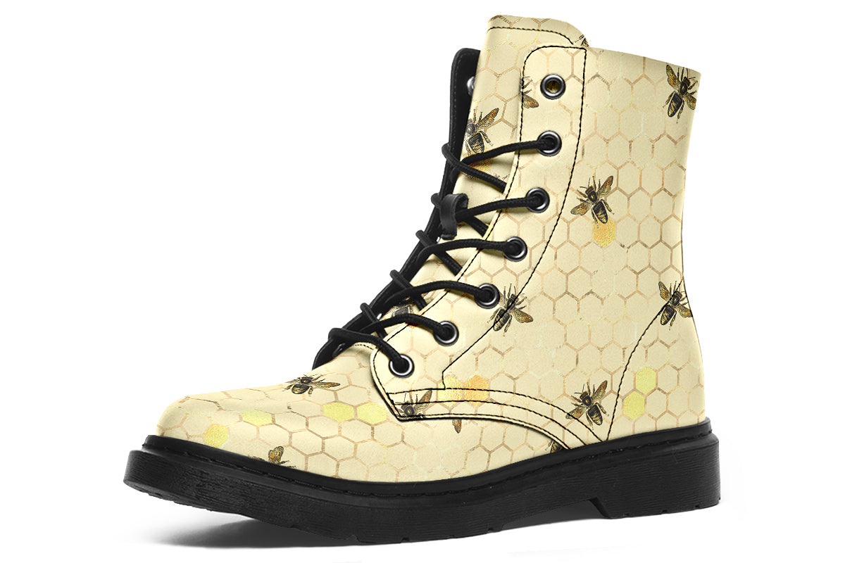 Light yellowish/cream boots with a pattern of faded gold honeycomb and sporadic bees