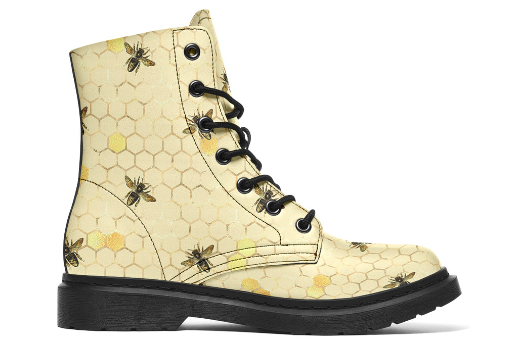 Light yellowish/cream boots with a pattern of faded gold honeycomb and sporadic bees