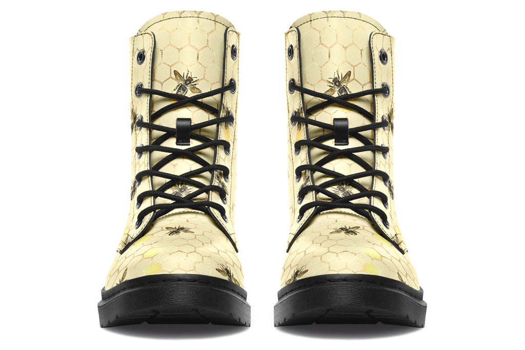 Light yellowish/cream boots with a pattern of faded gold honeycomb and sporadic bees