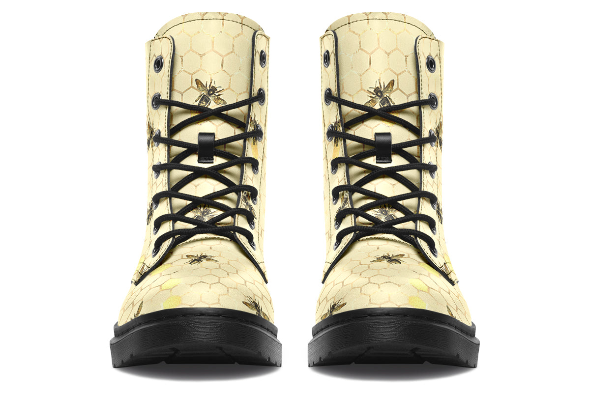 Light yellowish/cream boots with a pattern of faded gold honeycomb and sporadic bees