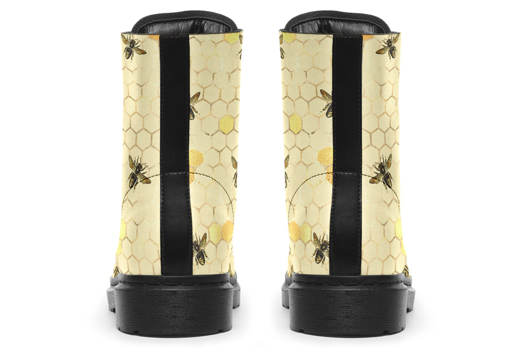 Light yellowish/cream boots with a pattern of faded gold honeycomb and sporadic bees