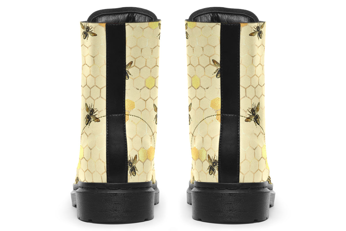 Light yellowish/cream boots with a pattern of faded gold honeycomb and sporadic bees