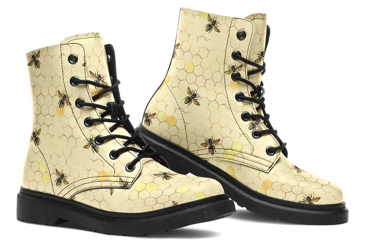 Light yellowish/cream boots with a pattern of faded gold honeycomb and sporadic bees