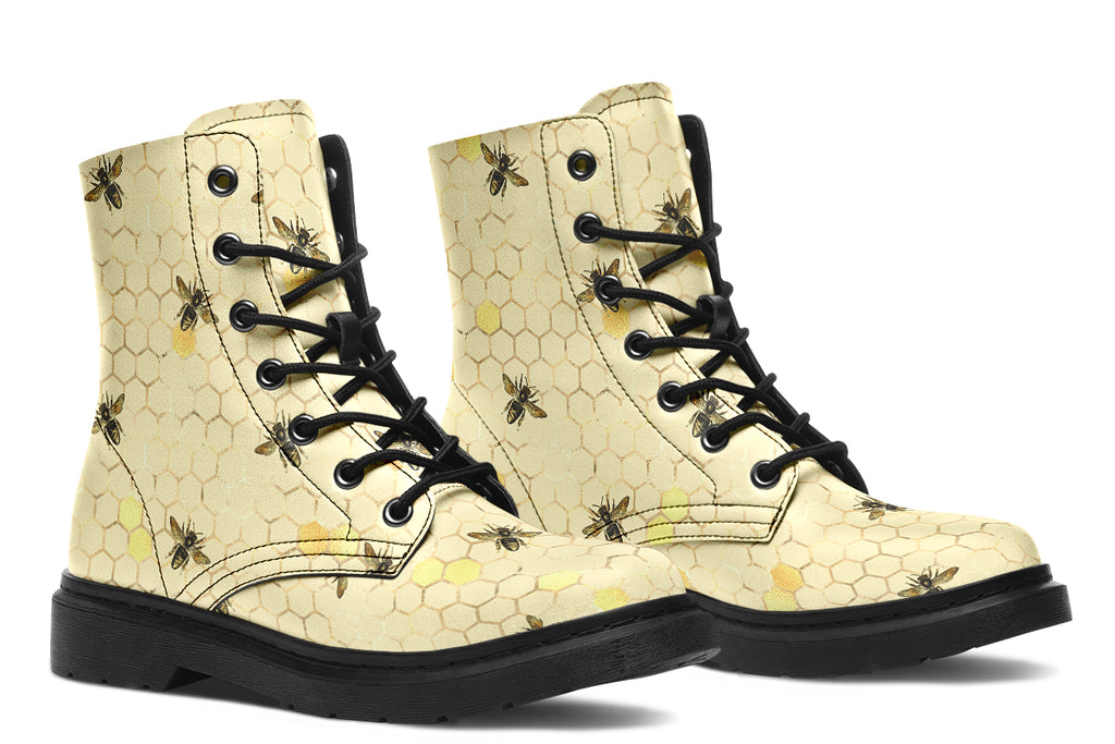 Light yellowish/cream boots with a pattern of faded gold honeycomb and sporadic bees