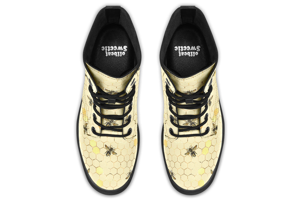 Light yellowish/cream boots with a pattern of faded gold honeycomb and sporadic bees