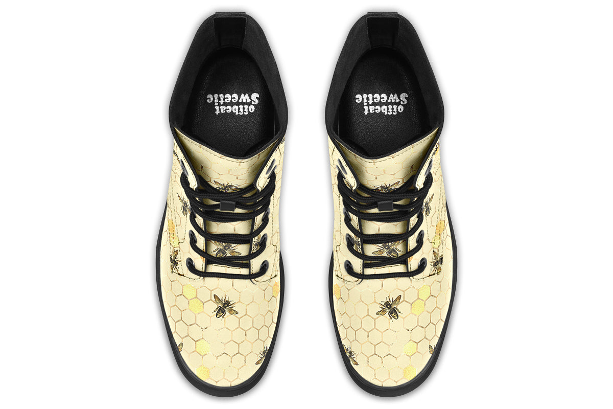 Light yellowish/cream boots with a pattern of faded gold honeycomb and sporadic bees