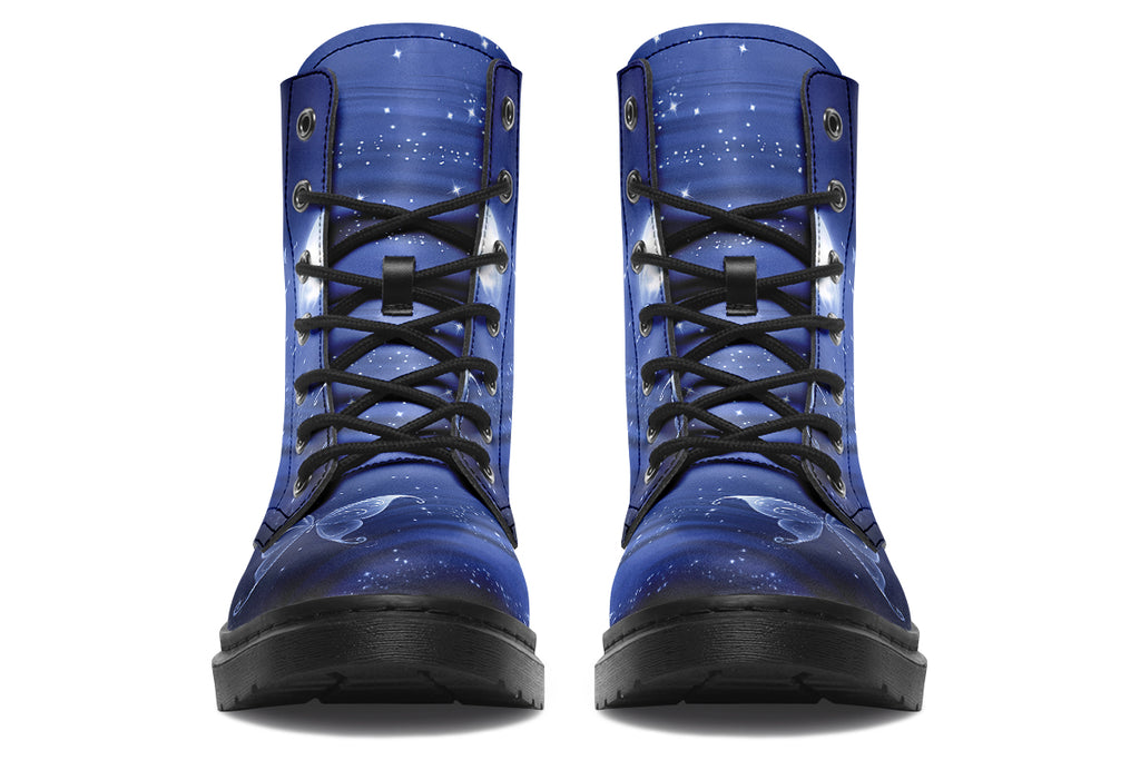Deep blue boots with an image of white butterflies flying at night around stars and the moon