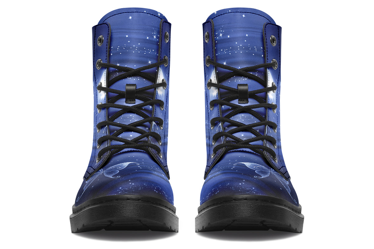 Deep blue boots with an image of white butterflies flying at night around stars and the moon