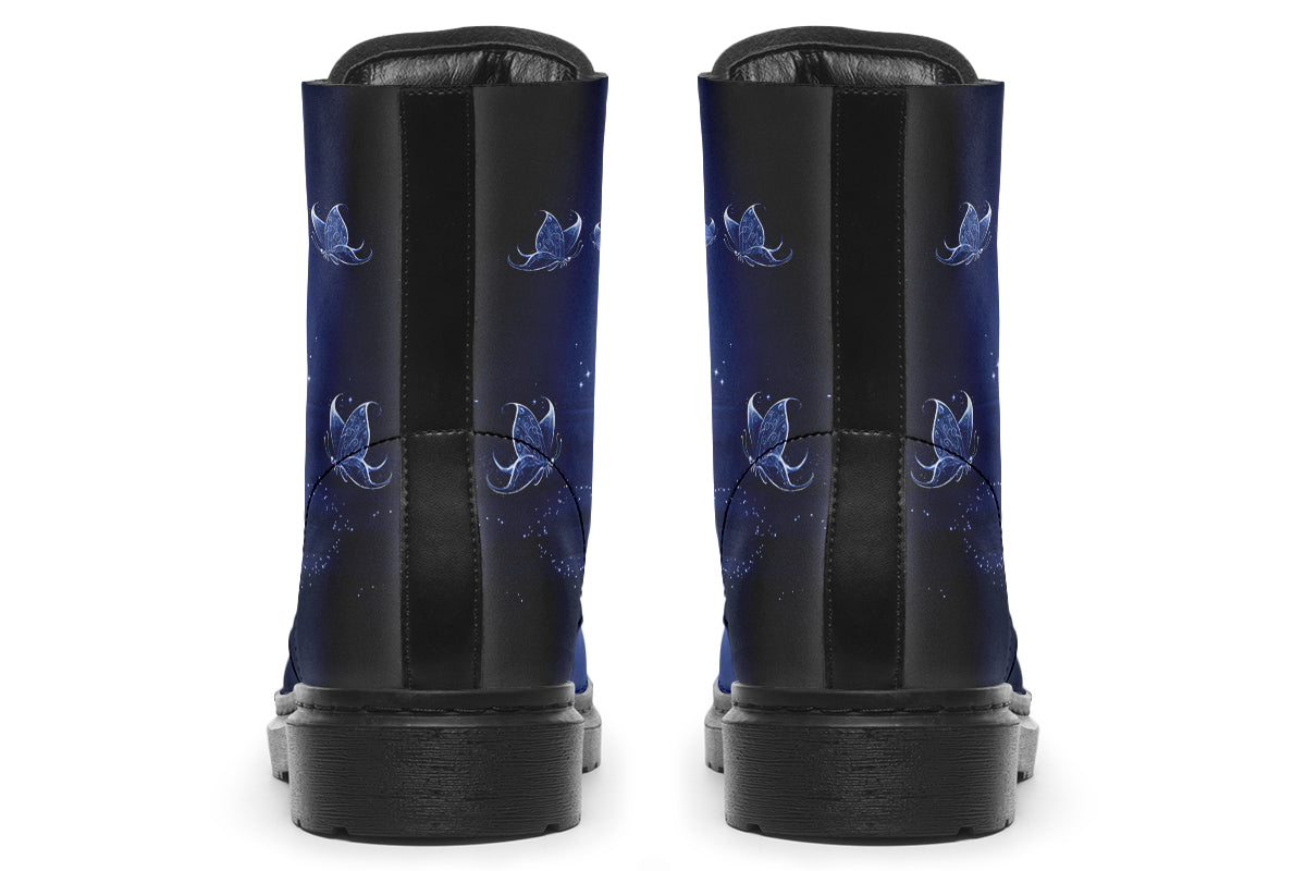 Deep blue boots with an image of white butterflies flying at night around stars and the moon