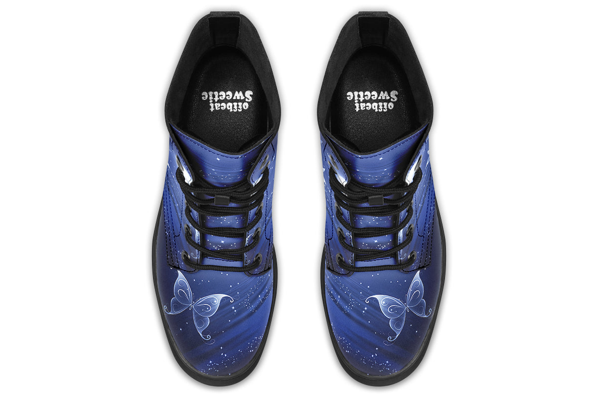 Deep blue boots with an image of white butterflies flying at night around stars and the moon