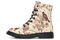 Cream coloured boots featuring images of brown tree branches with red berries, and red and black birds sitting on the branches.
