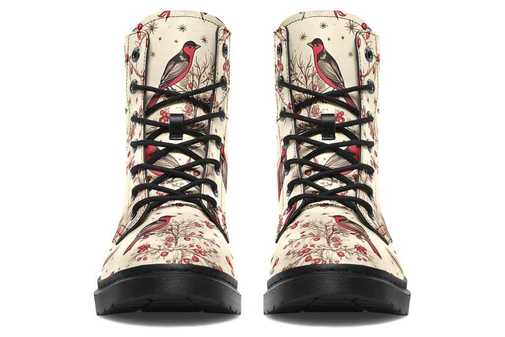 Cream coloured boots featuring images of brown tree branches with red berries, and red and black birds sitting on the branches.