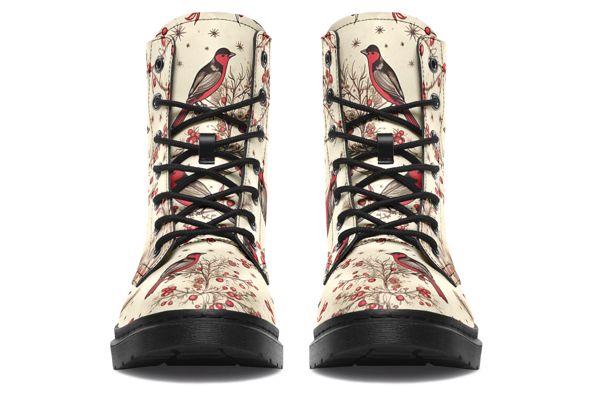 Cream coloured boots featuring images of brown tree branches with red berries, and red and black birds sitting on the branches.