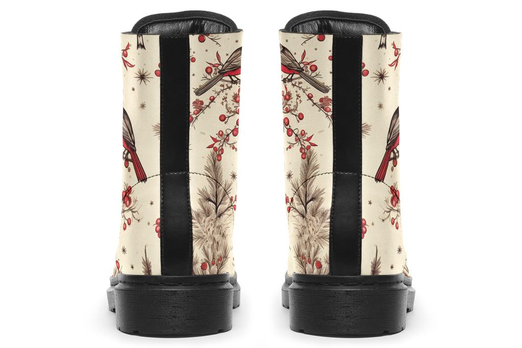 Cream coloured boots featuring images of brown tree branches with red berries, and red and black birds sitting on the branches.