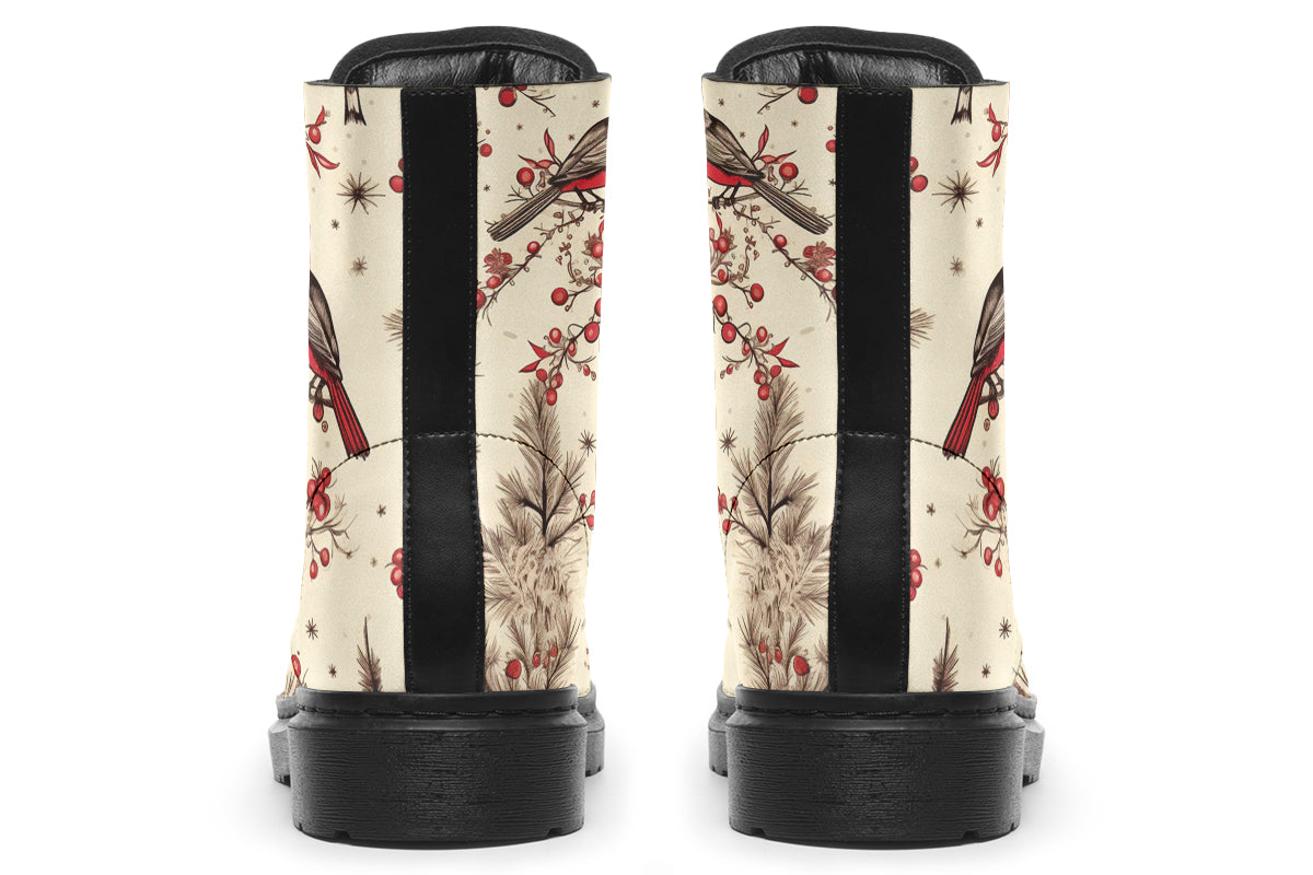 Cream coloured boots featuring images of brown tree branches with red berries, and red and black birds sitting on the branches.