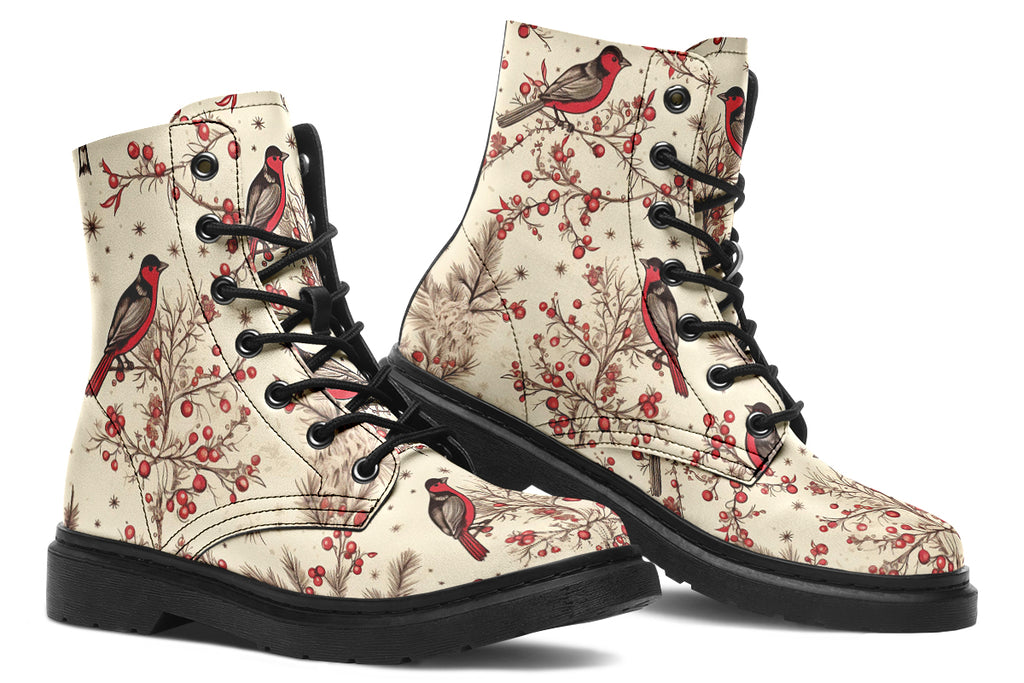 Cream coloured boots featuring images of brown tree branches with red berries, and red and black birds sitting on the branches.