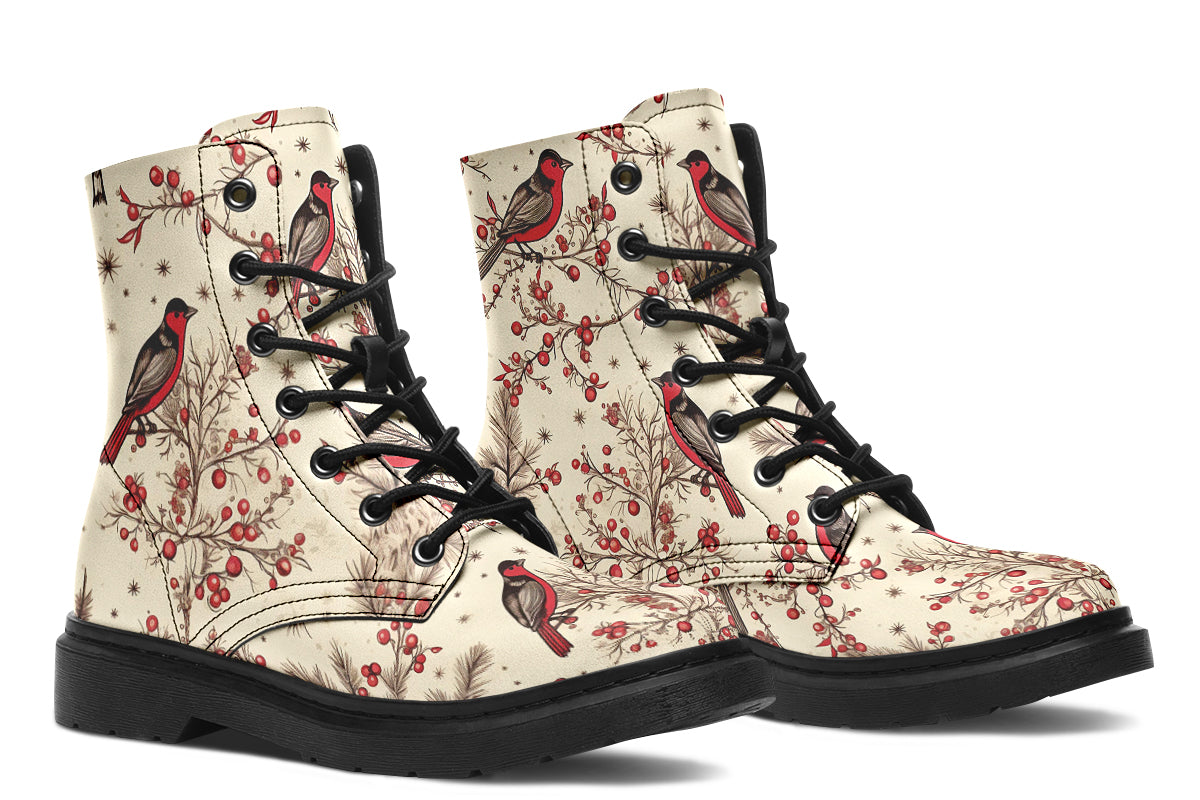 Cream coloured boots featuring images of brown tree branches with red berries, and red and black birds sitting on the branches.