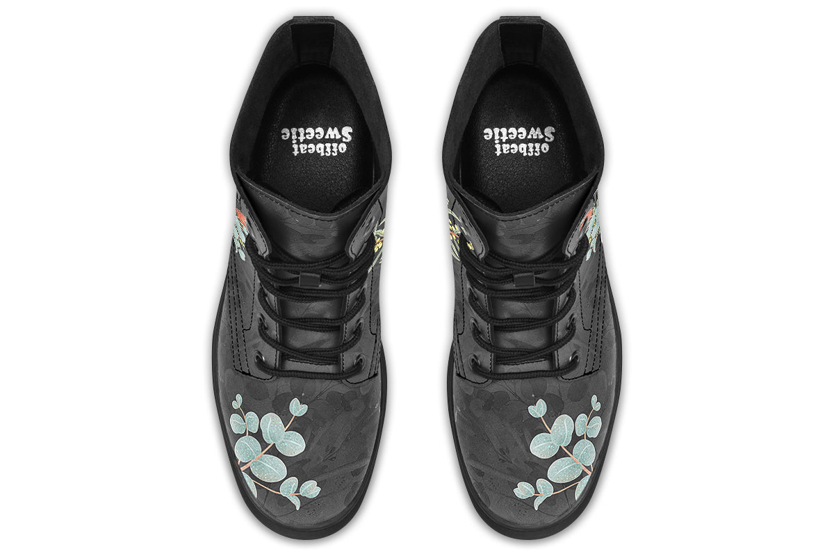 Boots with a subtle black leaves background, with an image of a cockatoo and Australian flora
