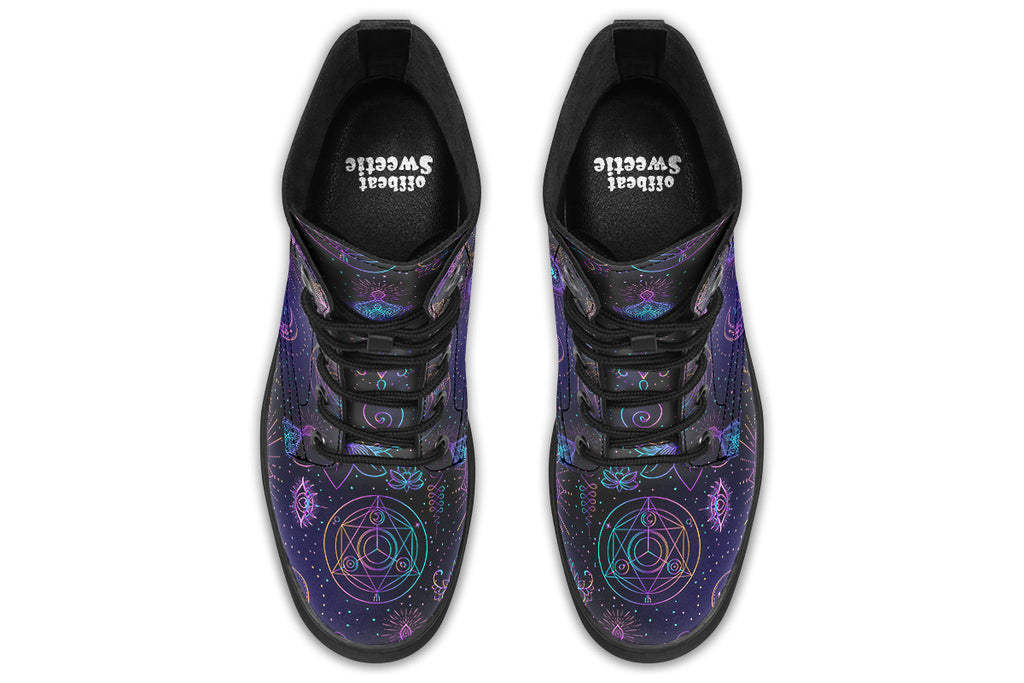 Boots featuring a dark violet, almost black background with a rainbow gradient pattern of different symbols such as a lotus flower, moon, star, decorative dots and swirls and a blue eye surrounded by a circle and line patterns.