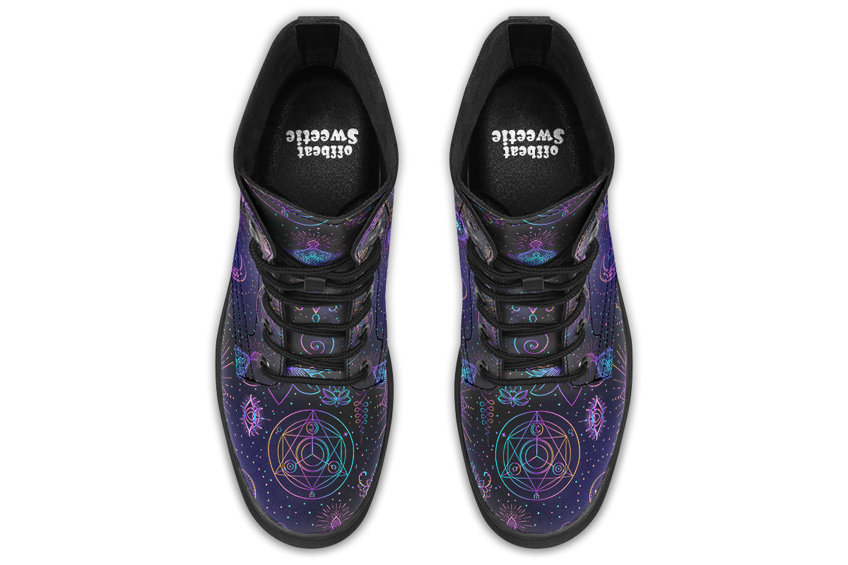 Boots featuring a dark violet, almost black background with a rainbow gradient pattern of different symbols such as a lotus flower, moon, star, decorative dots and swirls and a blue eye surrounded by a circle and line patterns.