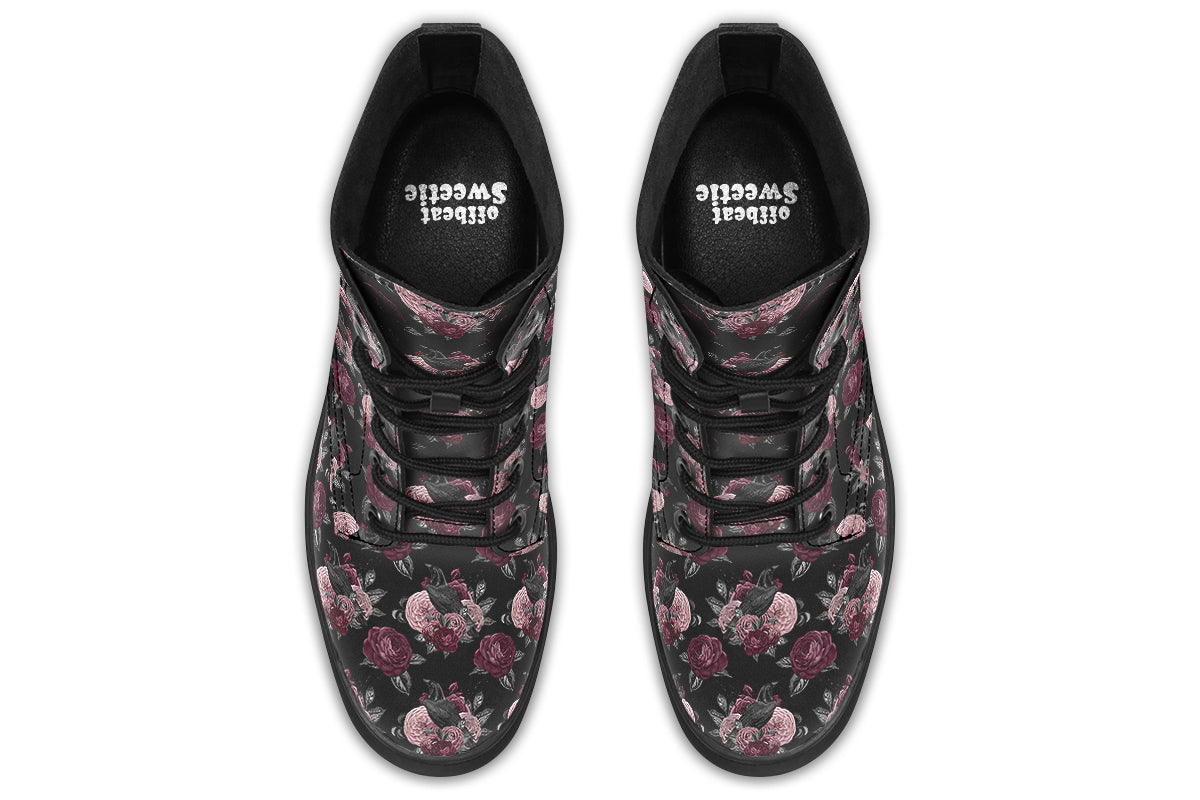 Black boots with a repetitive pattern of deep crimson and pink flowers with a black crow sitting in them