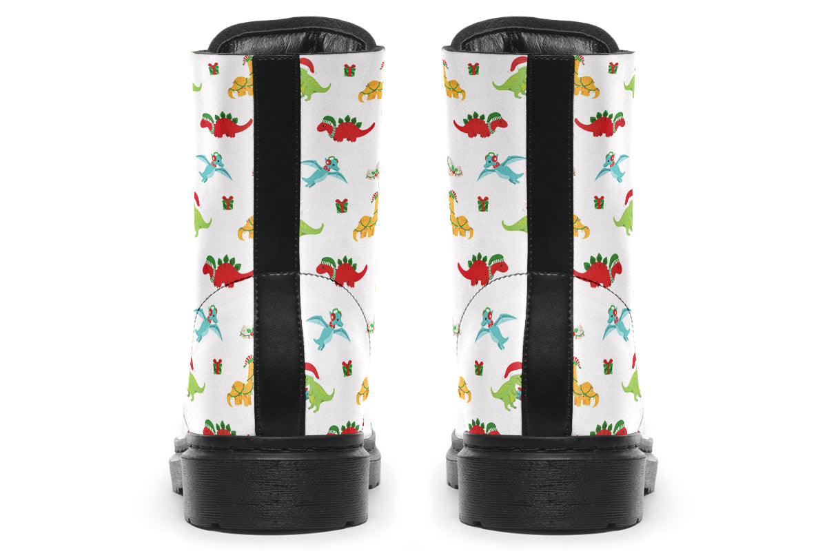 White boots featuring a pattern of different dinosaurs in Christmas hats and scarves. Some are holding gifts.