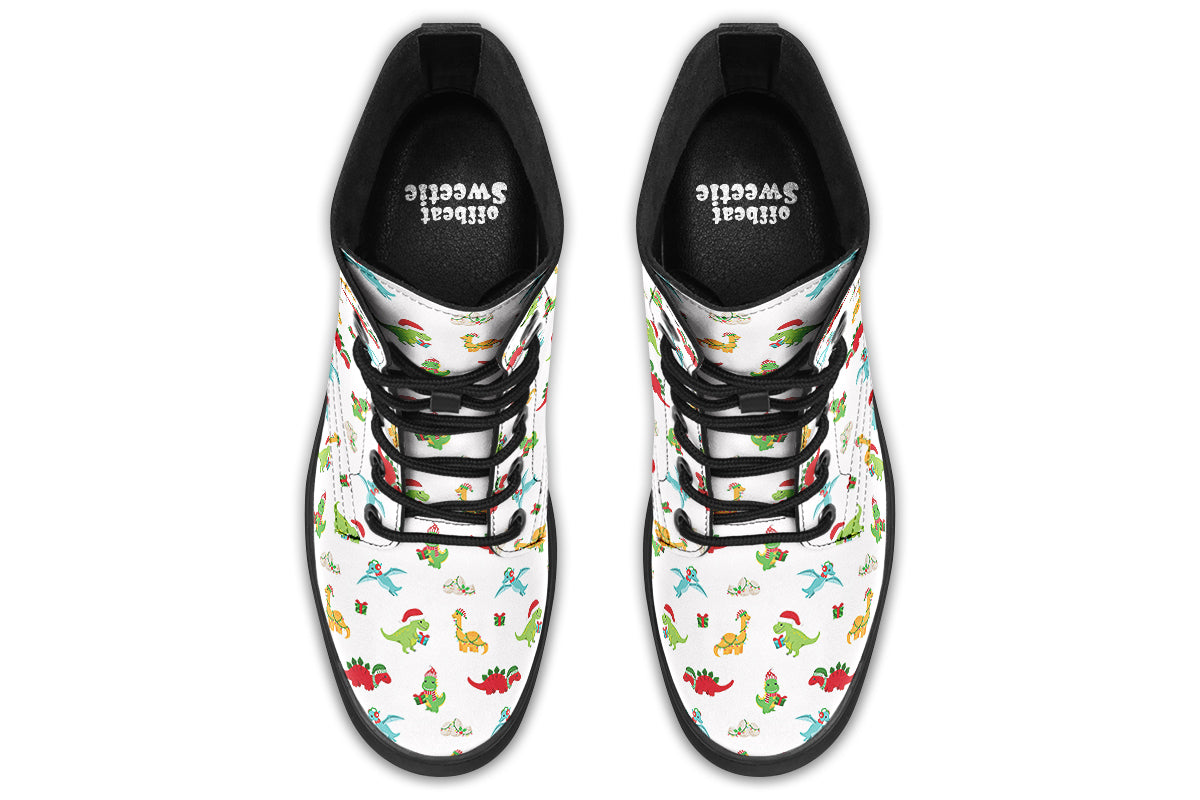 White boots featuring a pattern of different dinosaurs in Christmas hats and scarves. Some are holding gifts.