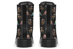Black boots featuring a pattern of different dinosaurs wrapped in Christmas lights. Some are also wearing Christmas hats.