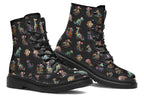 Black boots featuring a pattern of different dinosaurs wrapped in Christmas lights. Some are also wearing Christmas hats.