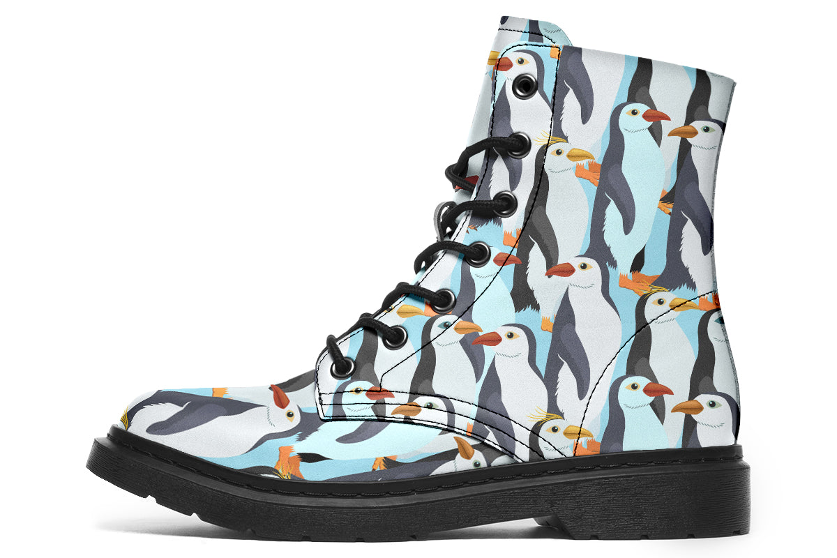 Light blue boots with a repetitive penguin pattern all over them.