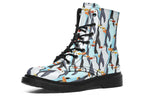 Light blue boots with a repetitive penguin pattern all over them.