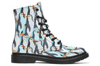 Light blue boots with a repetitive penguin pattern all over them.