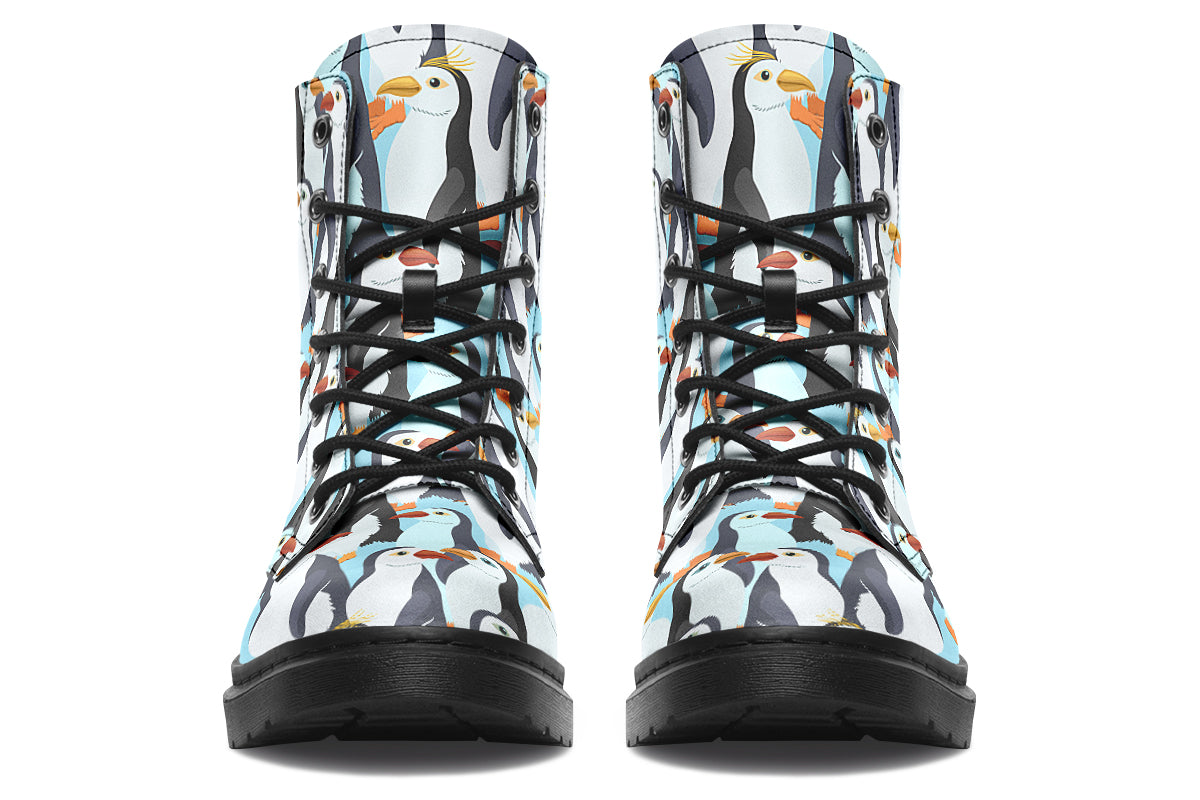 Light blue boots with a repetitive penguin pattern all over them.