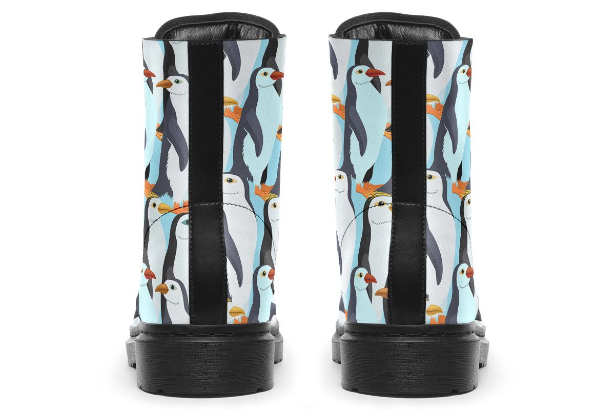 Light blue boots with a repetitive penguin pattern all over them.
