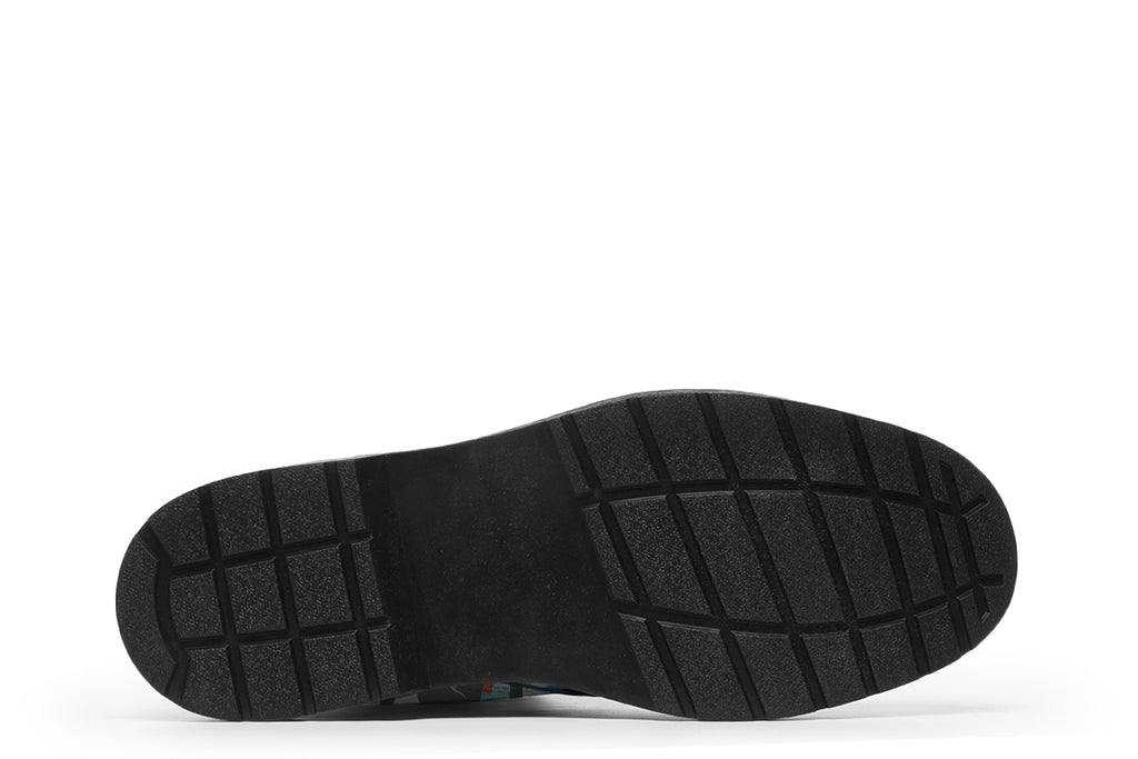 Light blue boots with a repetitive penguin pattern all over them.