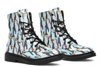 Light blue boots with a repetitive penguin pattern all over them.