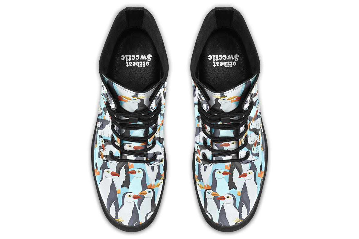 Light blue boots with a repetitive penguin pattern all over them.