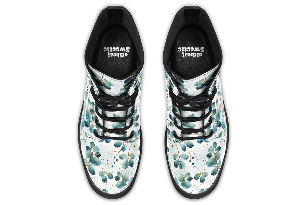 White boots featuring a green eucalyptus leaves pattern