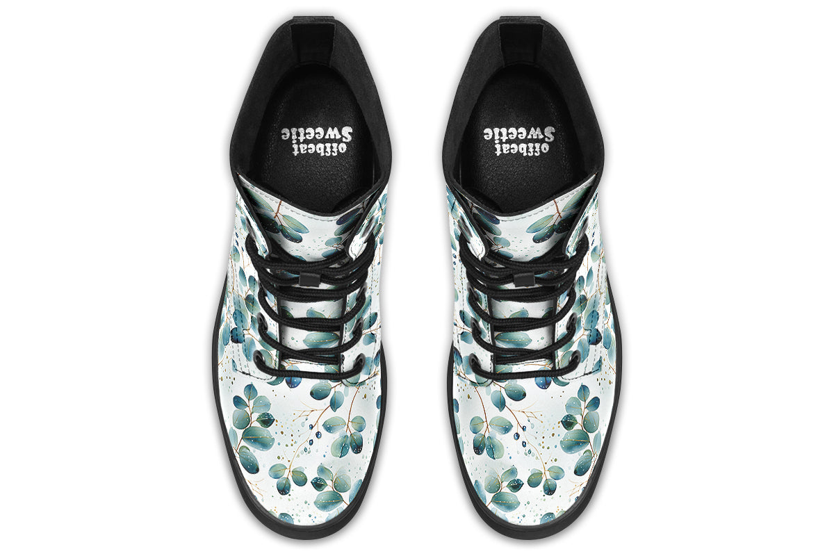 White boots featuring a green eucalyptus leaves pattern