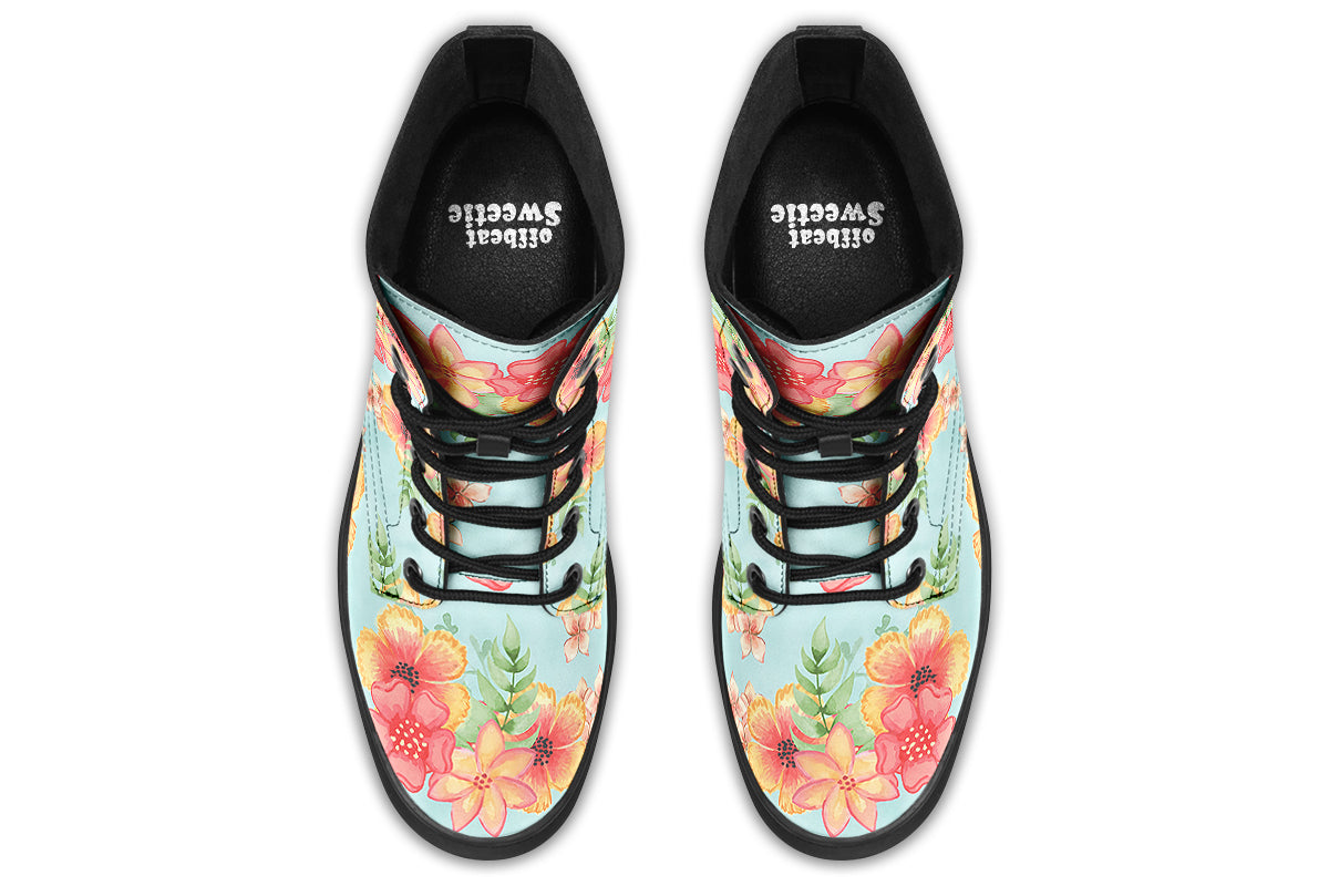Light blue boots with a pattern of florals in oranges and pinks.