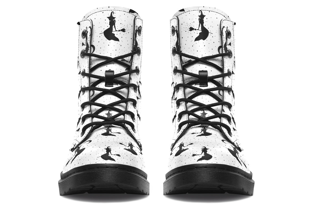 White boots with a repetitive black pattern of the silhouettes of witches on broomsticks